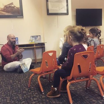 Mayor Baichi reading to the children